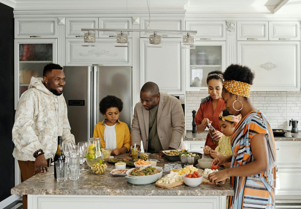 A joyful family together in the kitchen, preparing and enjoying a meal.